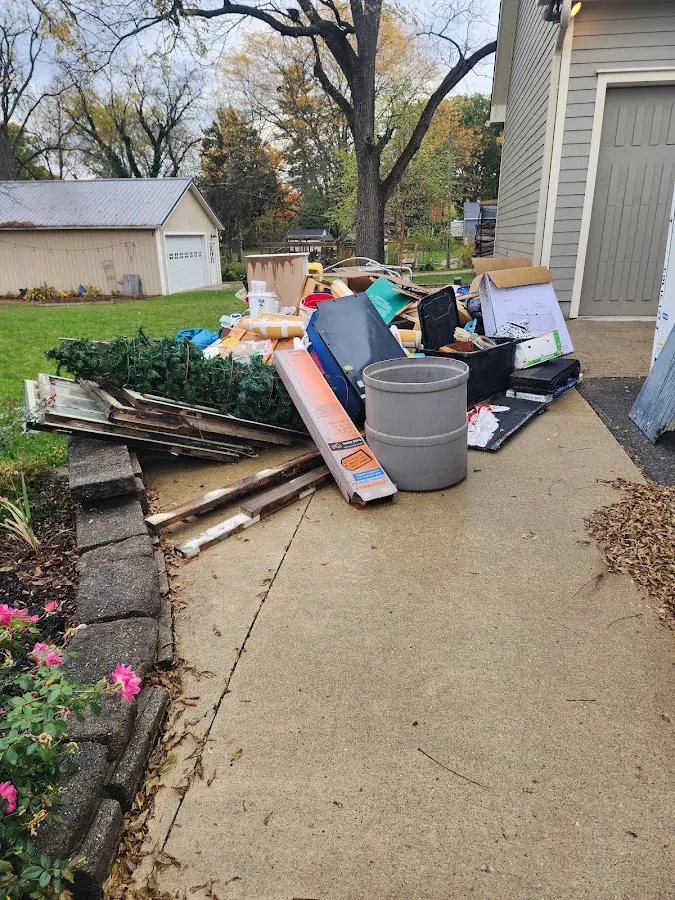 Dumpster being loaded with debris for 12 Yard Dumpster Rental in Warwick